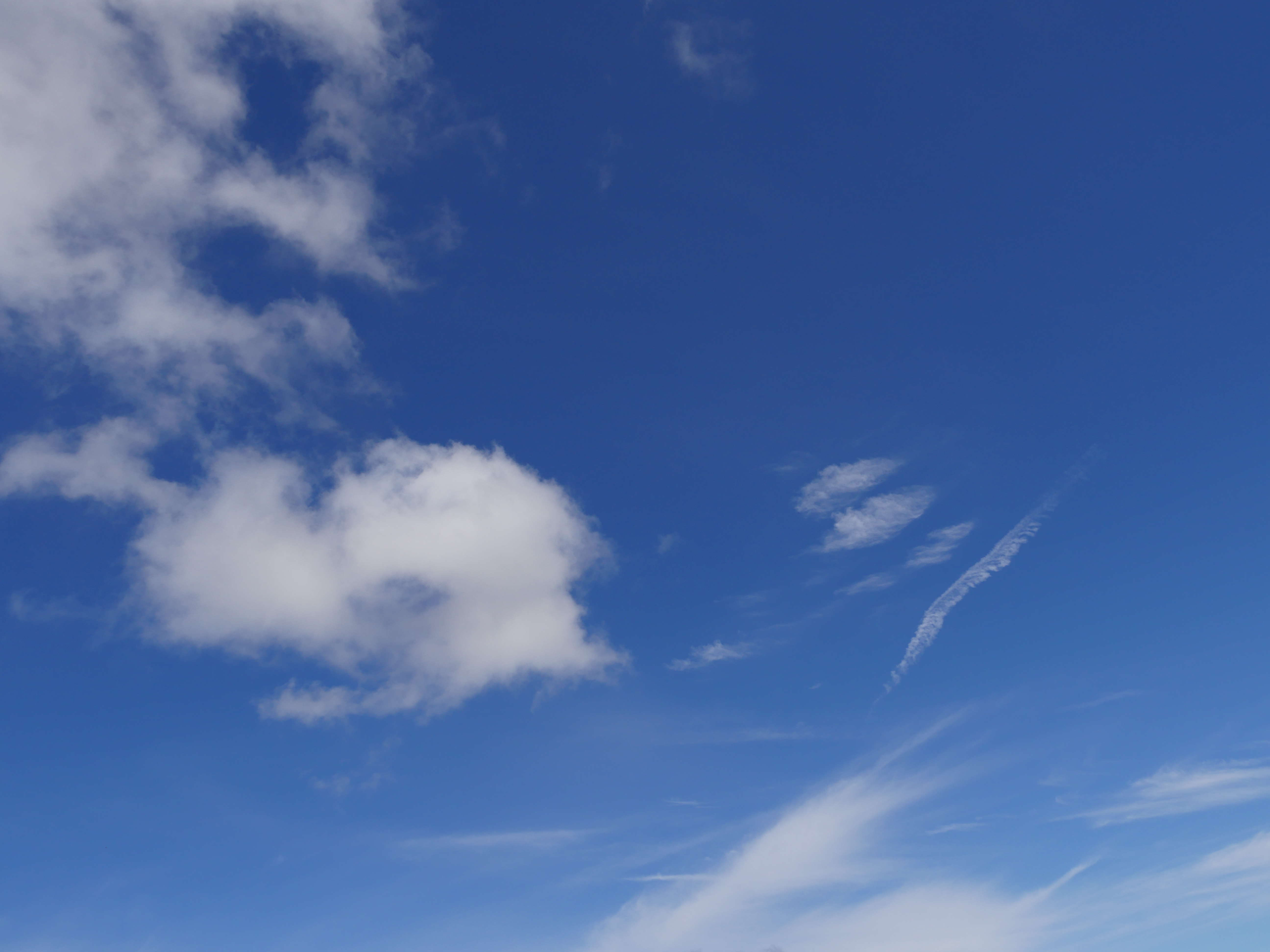 whispy clouds on a blue sky