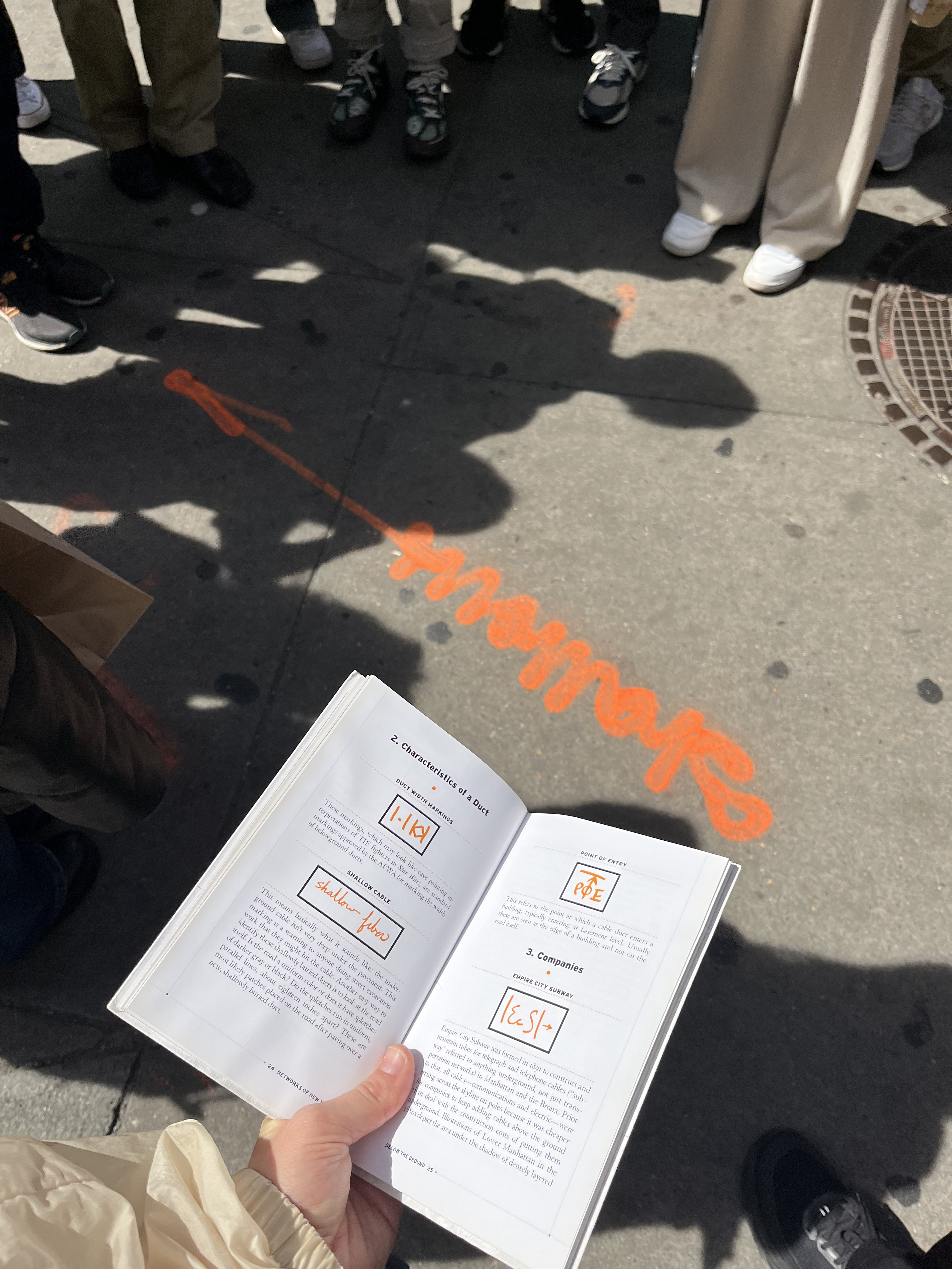 Book open to spread to decode the mysterious cursive spraypaintings by communication companies