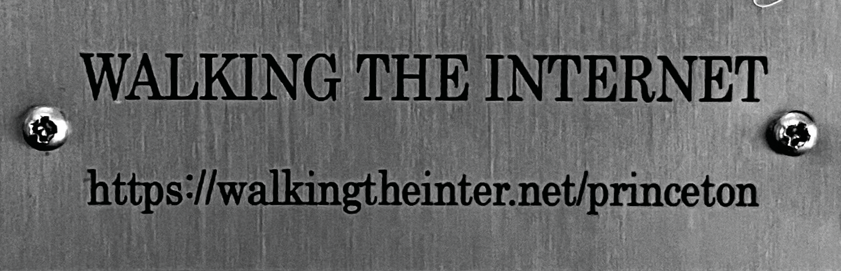tiny metal plaque that says WALKING THE INTERNET with a url: walkingtheinter.net/princeton